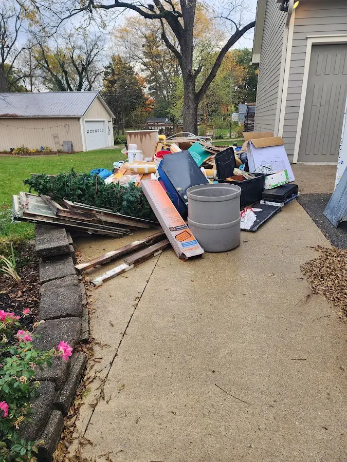 Dumpster being loaded with debris for Roofing Dumpster Rental in St. Thomas